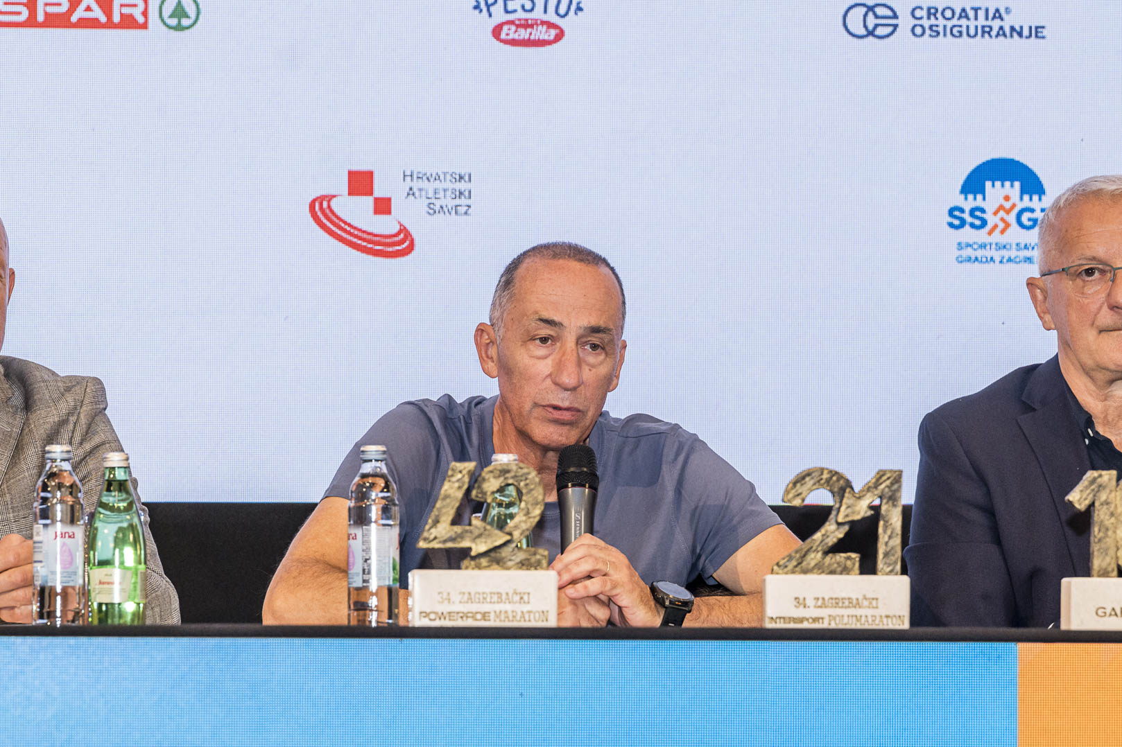 A speaker at the Zagreb Marathon press conference with the race trophies